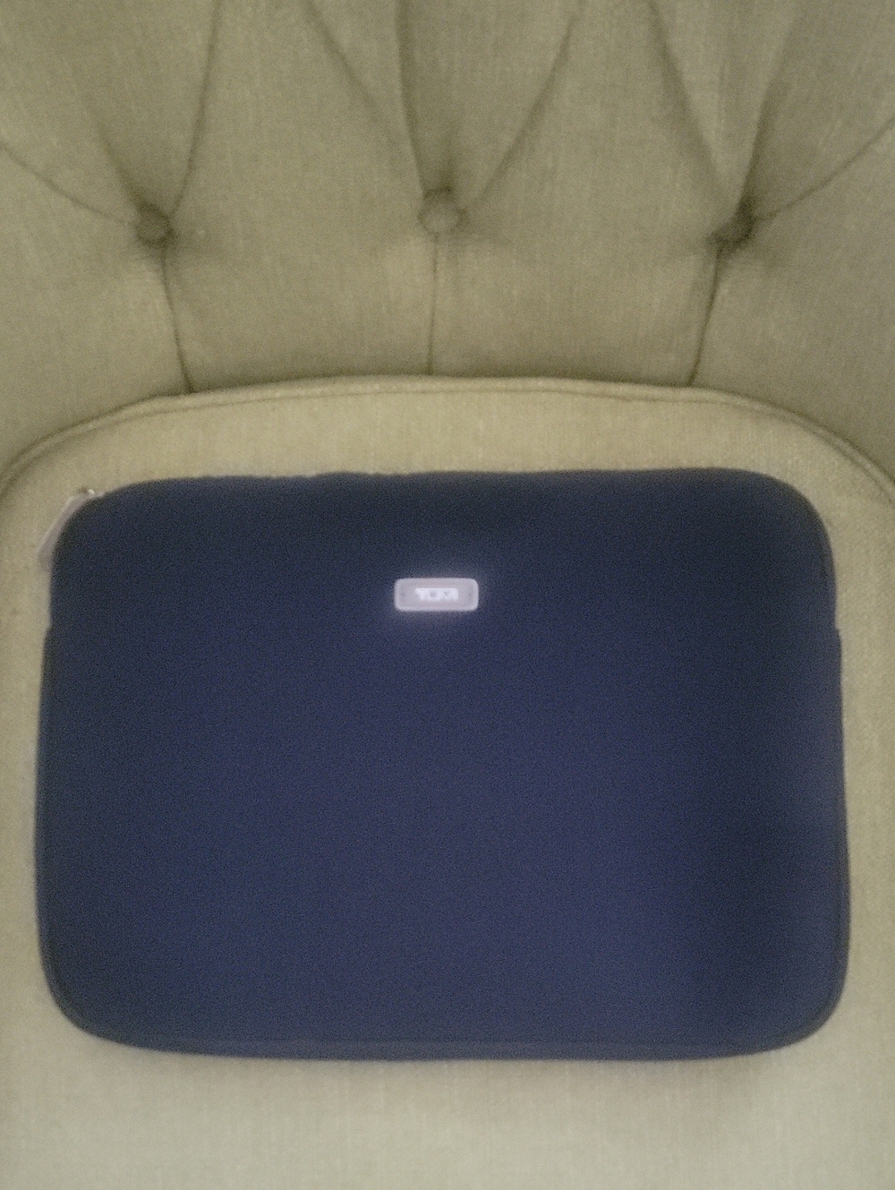 Tumi Black Sleeve with Beige Logo Patch